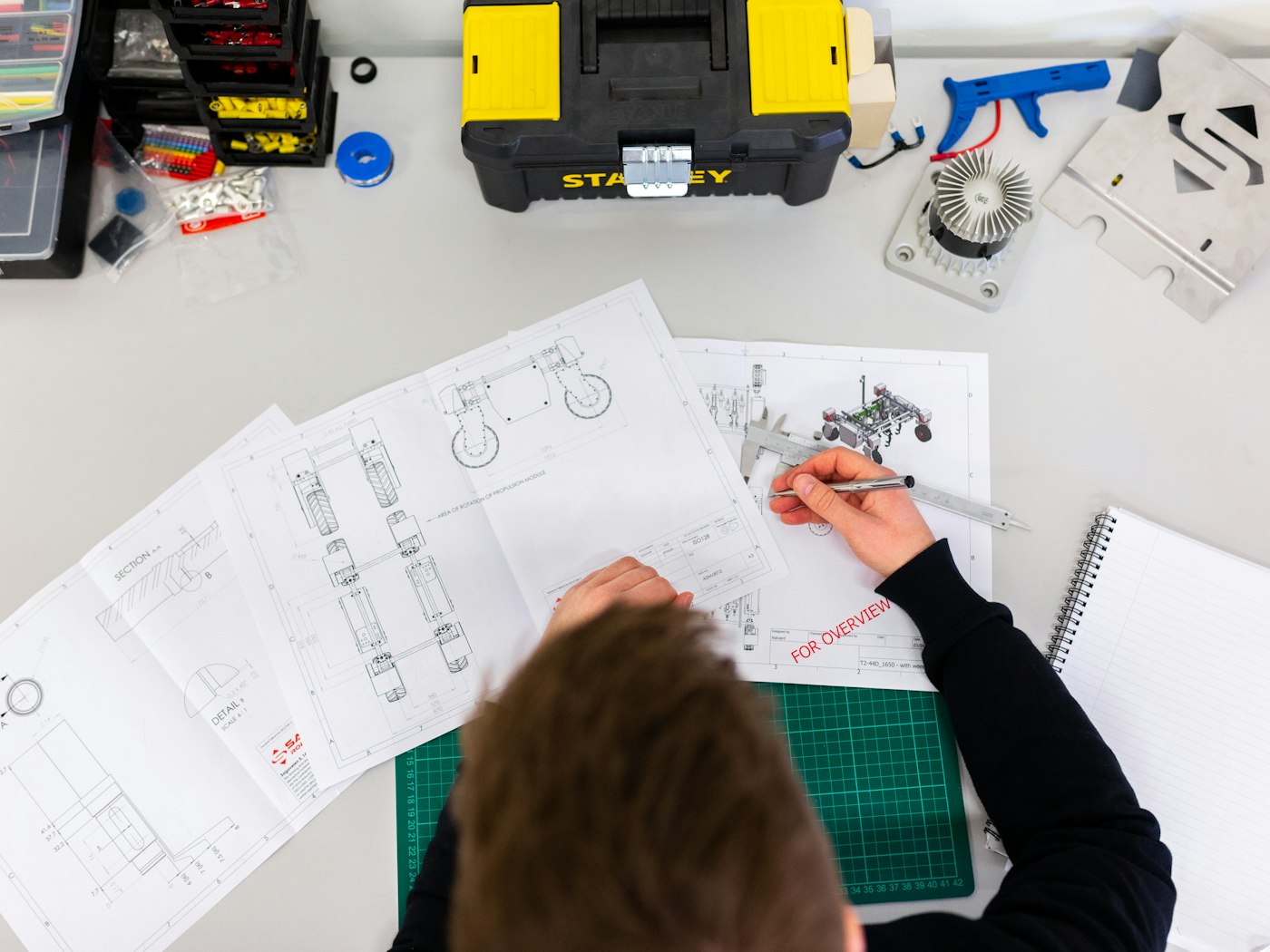 Engineer reviewing low-voltage system drawings at a desk