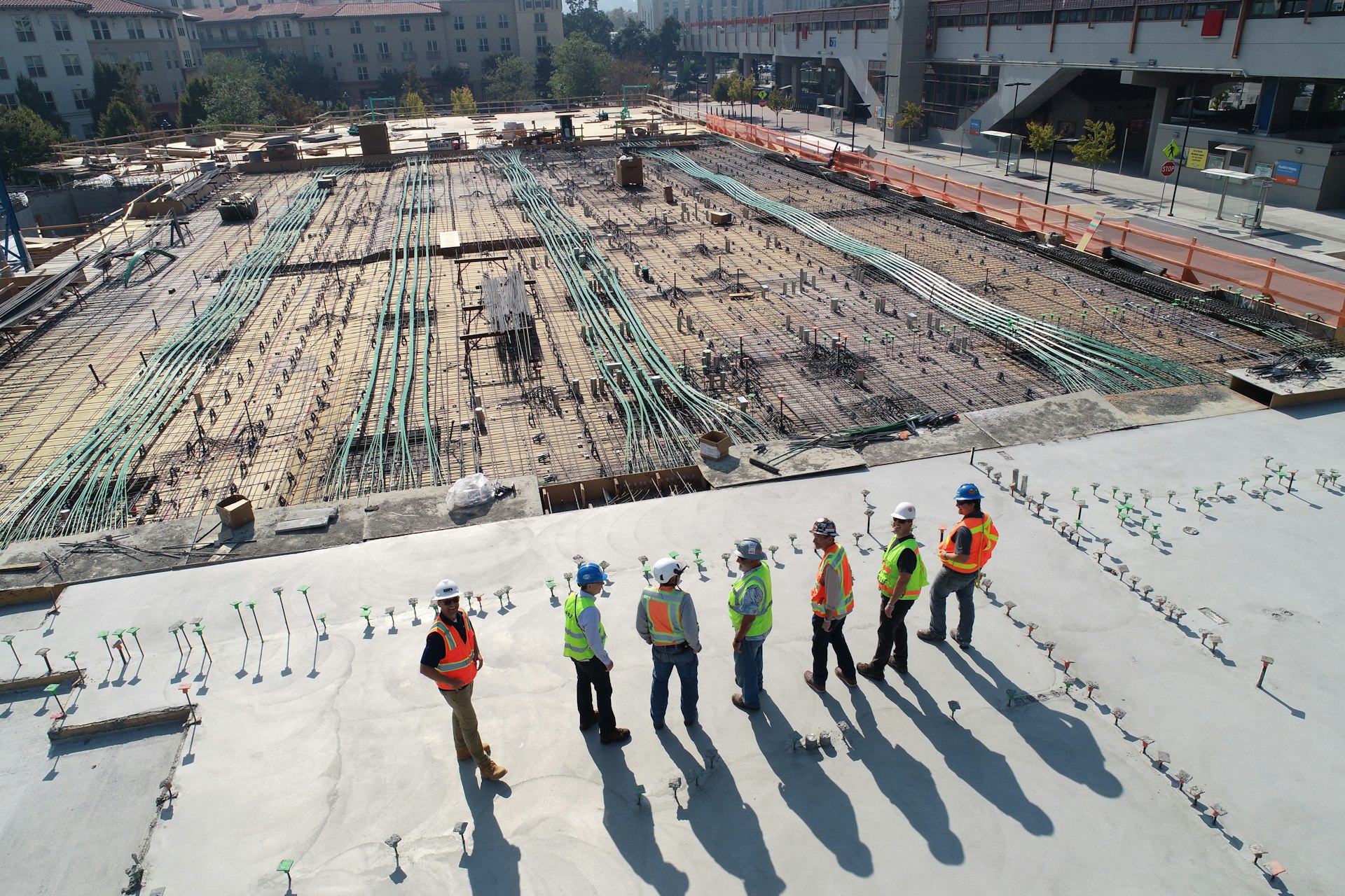 Aerial view of structured cabling and conduit rough-in on an active commercial construction site