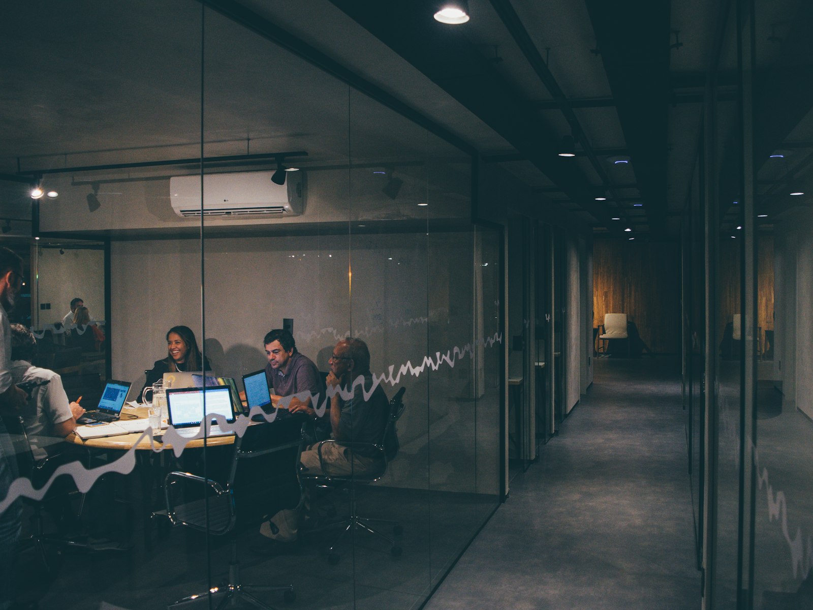 Team working in a modern office meeting room in the evening