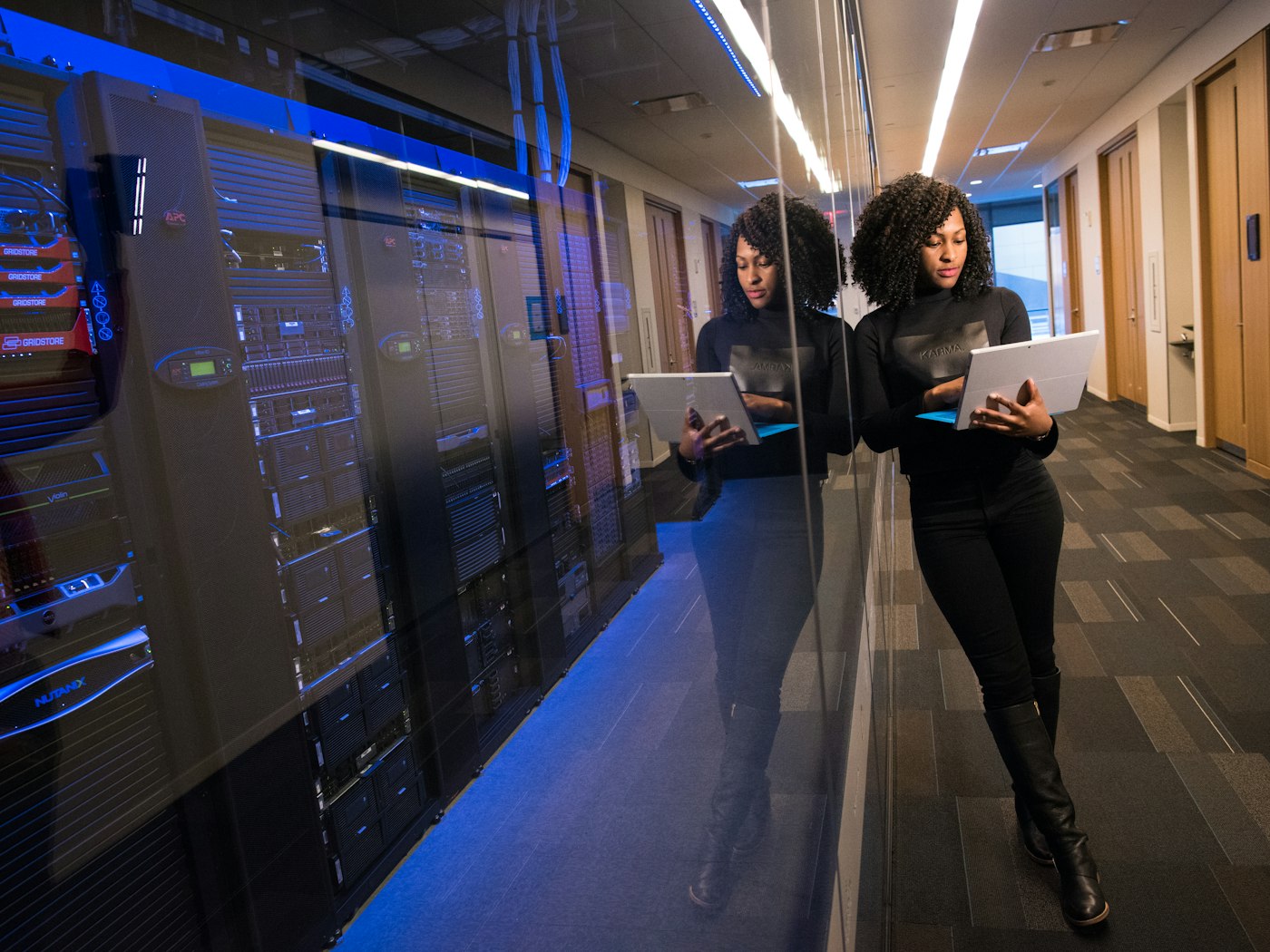 Technician reviewing systems in a server room